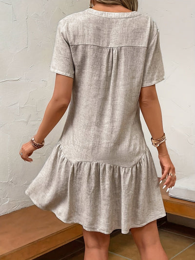 Kleid mit Schnitt, Faldas und Blumentasche Grau